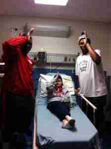 Rebel Def. tackle Herbert Moore (left) and NEMCC LB Marcus Robinson (right) visit Chance in the hospital. (Photo courtesy of The Tetrick Family.)