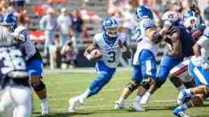Terry Wilson runs with the ball.
